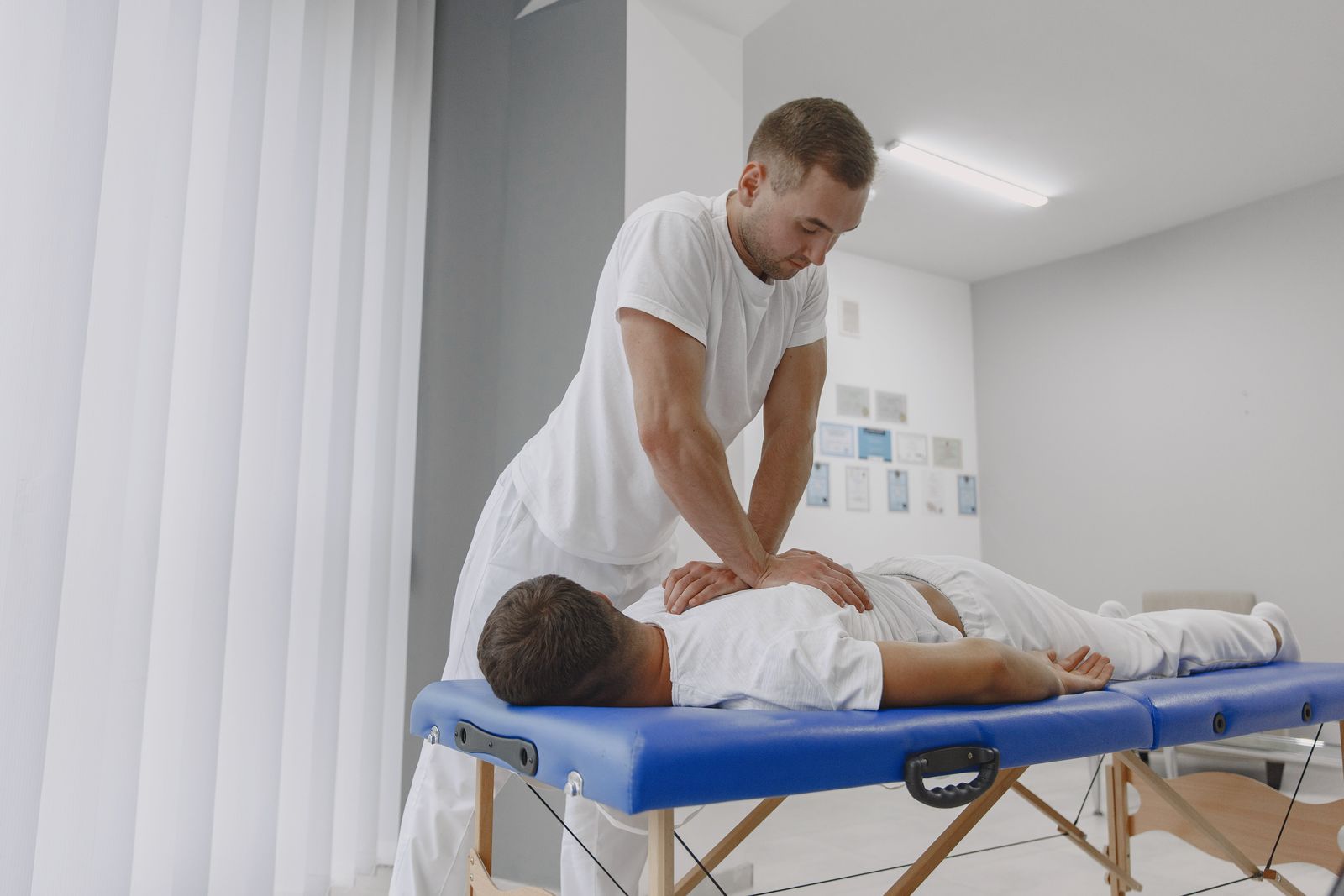 Physiotherapist treating a patient's back in a clinic